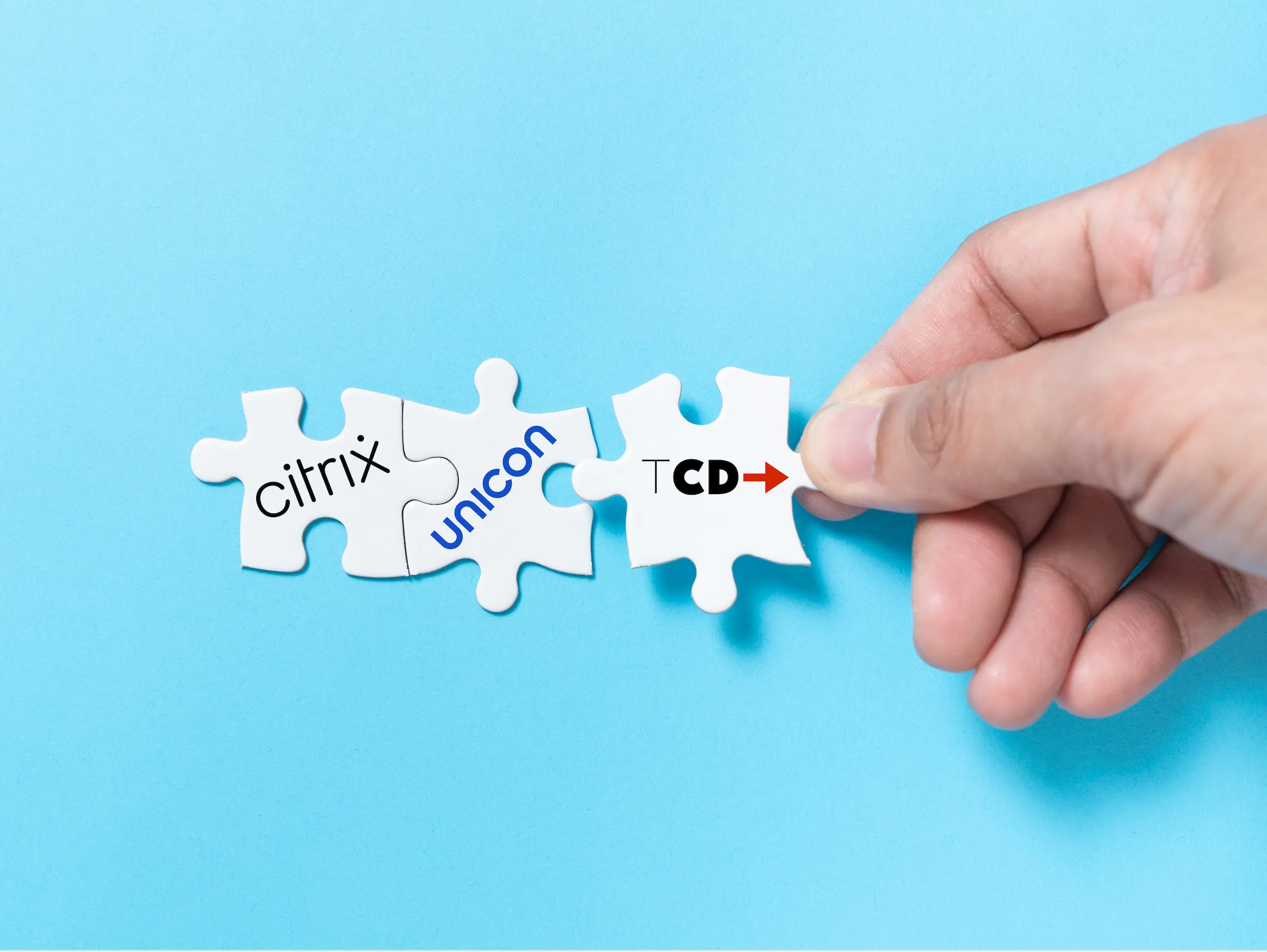 Hand connecting puzzle pieces labeled Citrix, Unicon, and TCD, representing seamless compatibility between virtual desktop platforms and thin client endpoints